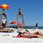 Girls, lifeguards and blue flags