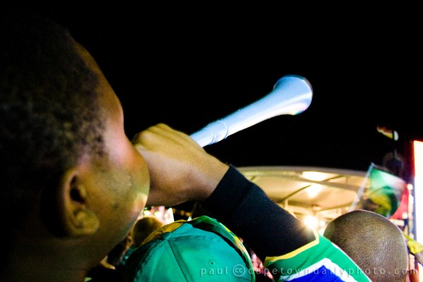 Blowing a vuvuzela