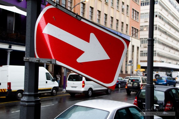 Bent one-way arrow sign