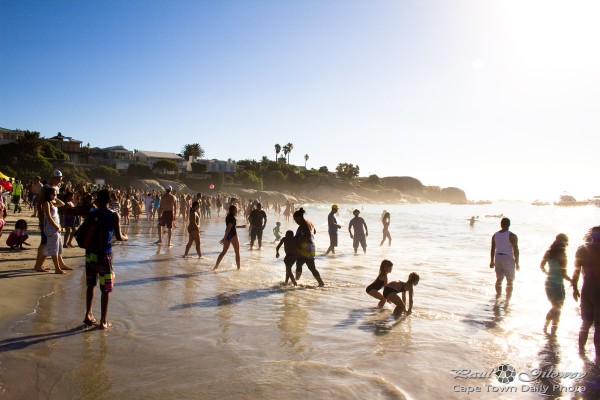People at the beach wading into the sea